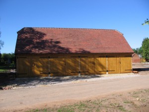 Oak framed 4 bay garage with equal eaves and barn hips by Shires Oak Buildings
