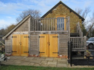 Oak framed storeroom with balcony and staircase by Shires Oak Buildings