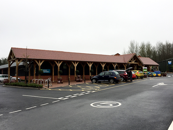 Oak framed porch and walkway for Mappleborough Green Garden Centre by Shires Oak Buildings