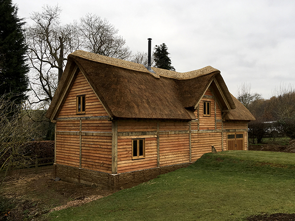 Oak framed mill building with thatched roof by Shires Oak Buildings