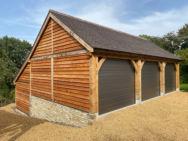 Oak framed 3 bay garage & store with automated doors by Shires Oak Buildings